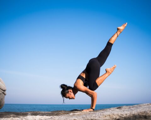 low angle view of woman relaxing on beach against blue sky