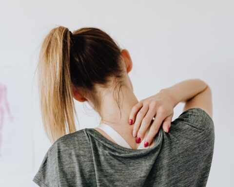 woman touching her back