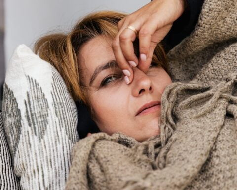 a woman pressing her nose bridge