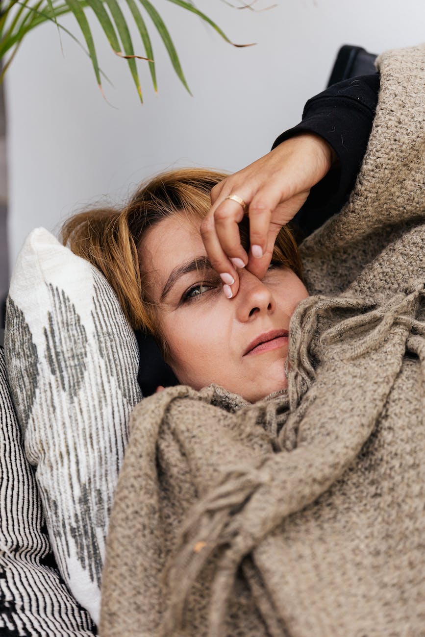 a woman pressing her nose bridge